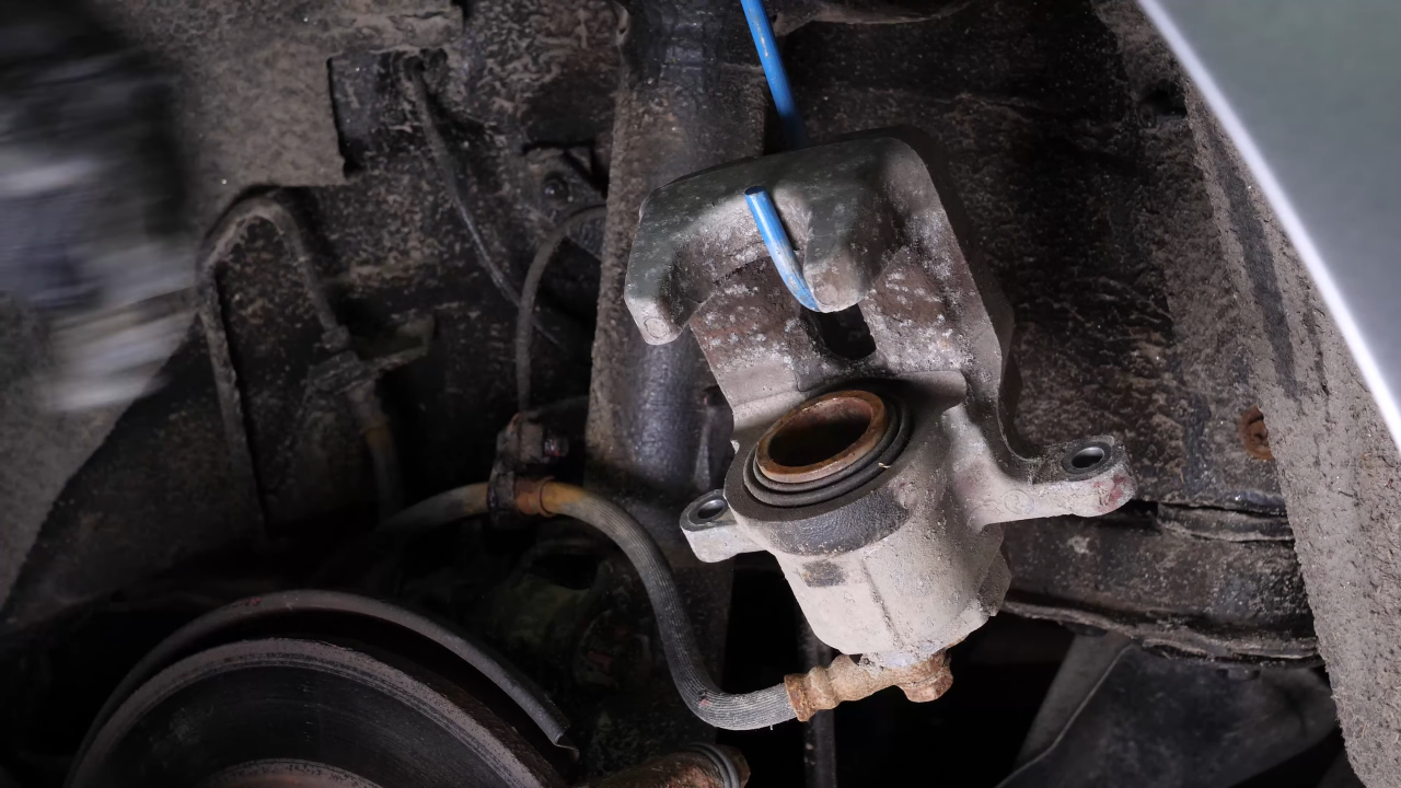 Hang the brake caliper on the strut