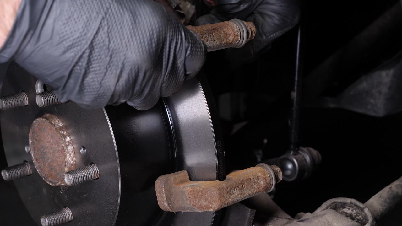 Put the brake caliper mount back on