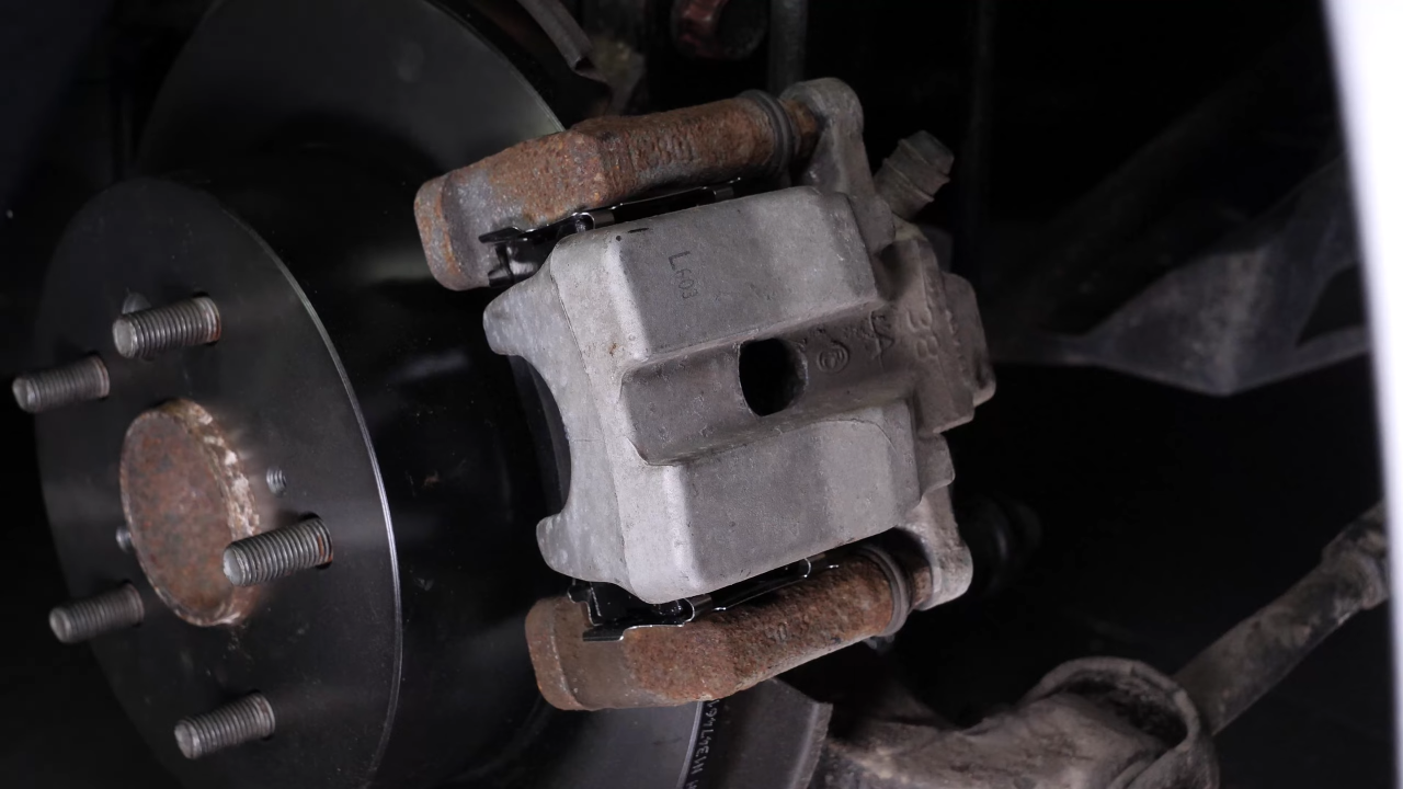 Put the brake caliper back
