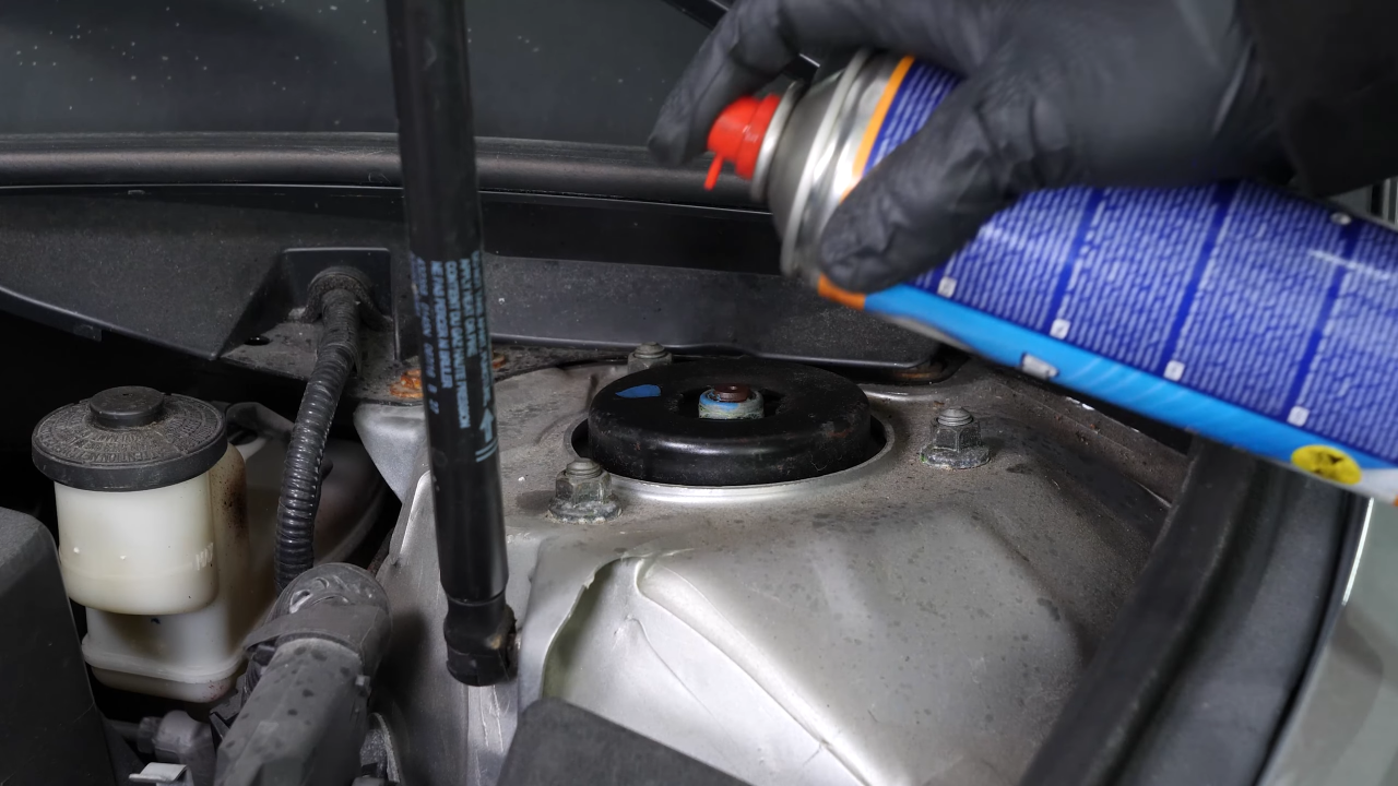 Unscrew the strut mount bearing nuts