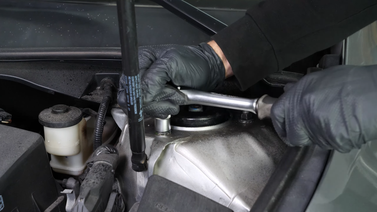 Unscrew the strut mount bearing nuts