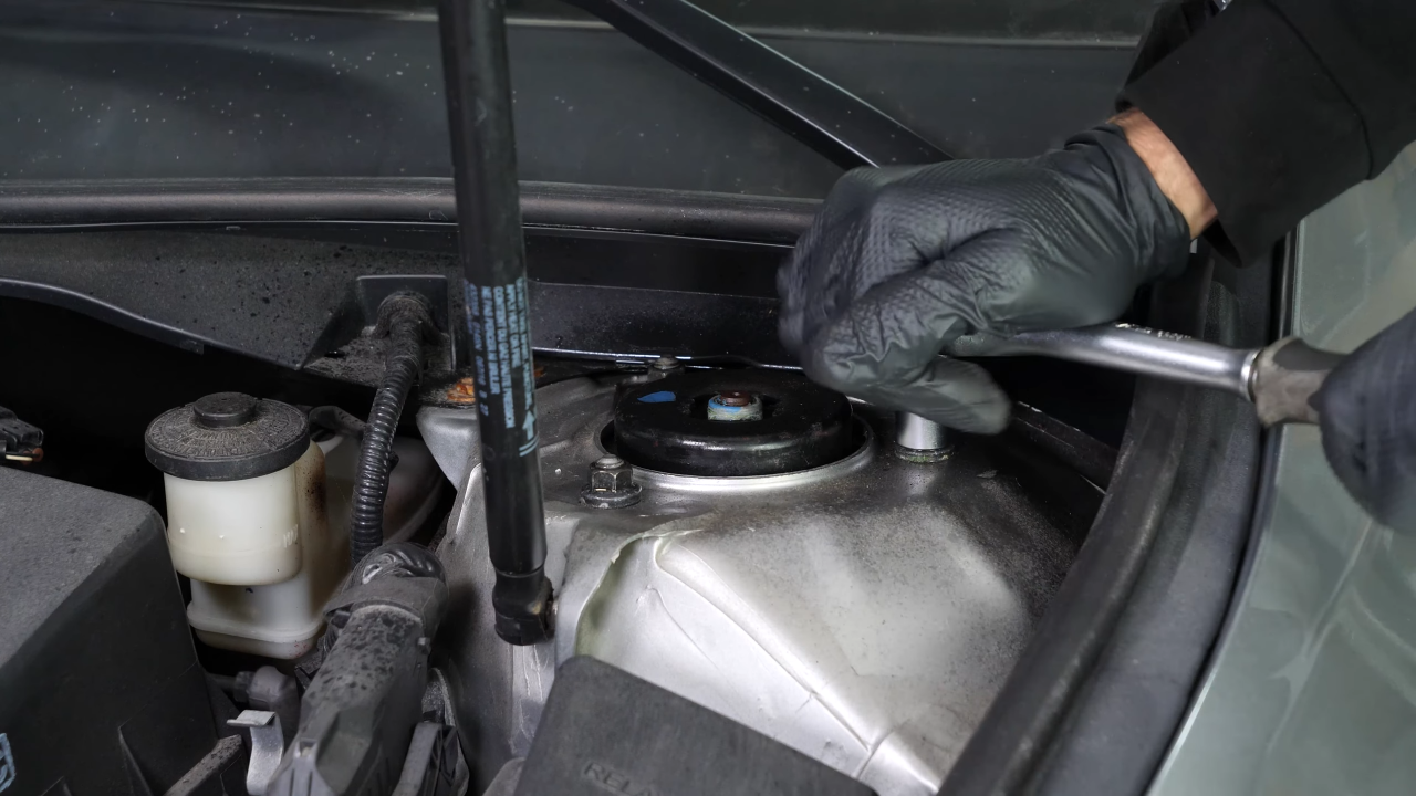 Unscrew the strut mount bearing nuts
