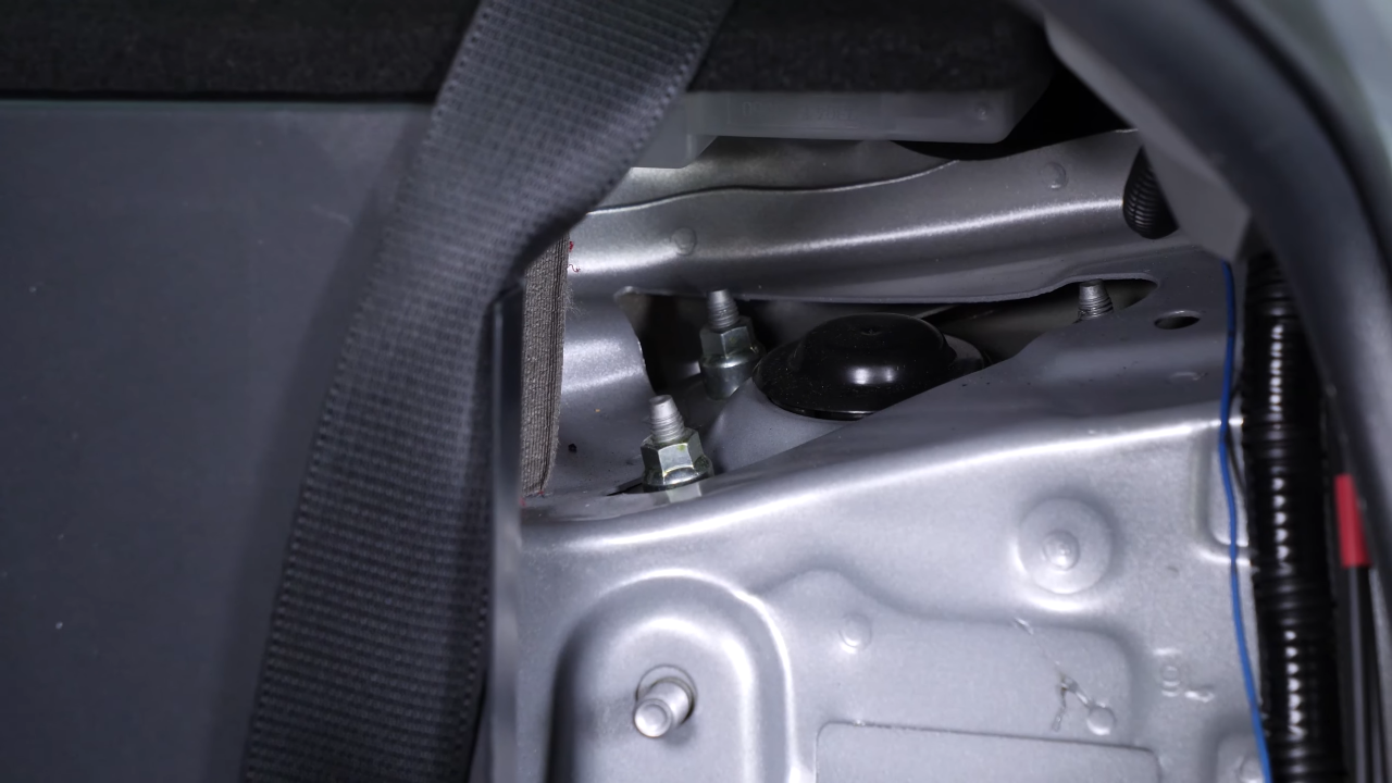 Unscrew the strut mount bearing nuts