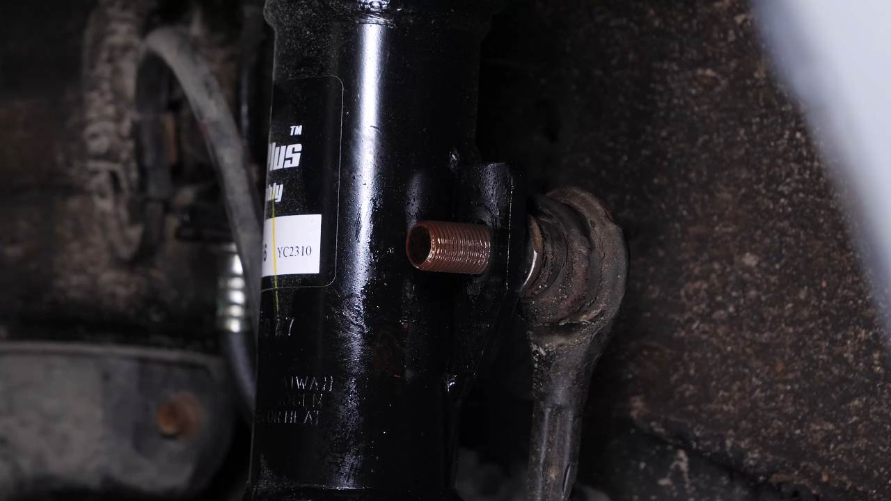 Unscrew the upper ball joint