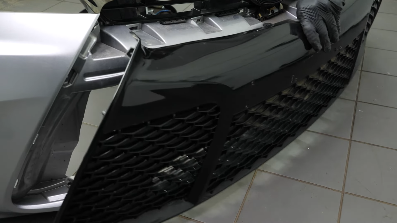 Remove the screws and tabs holding the bumper grille