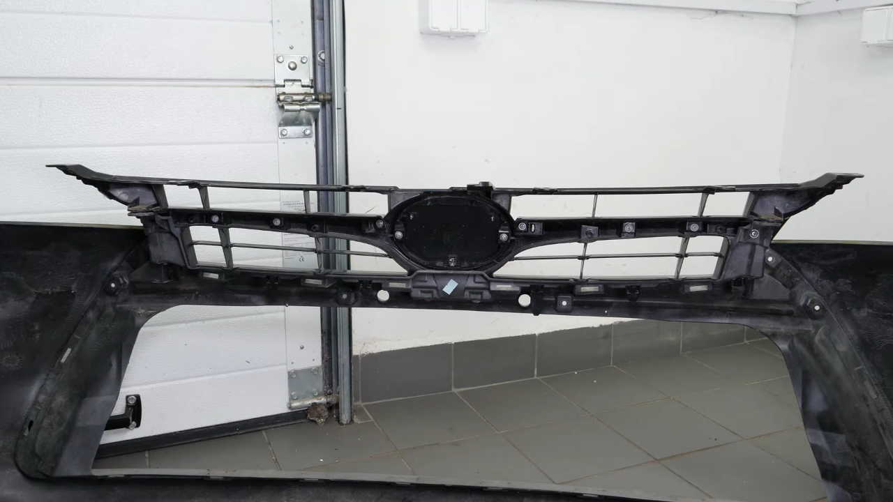 Remove the screws and tabs holding the bumper grille
