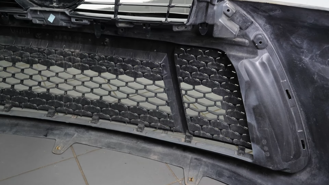 Put the screws and tabs holding the bumper grille back