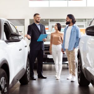couple talking to a car agent in a showroom