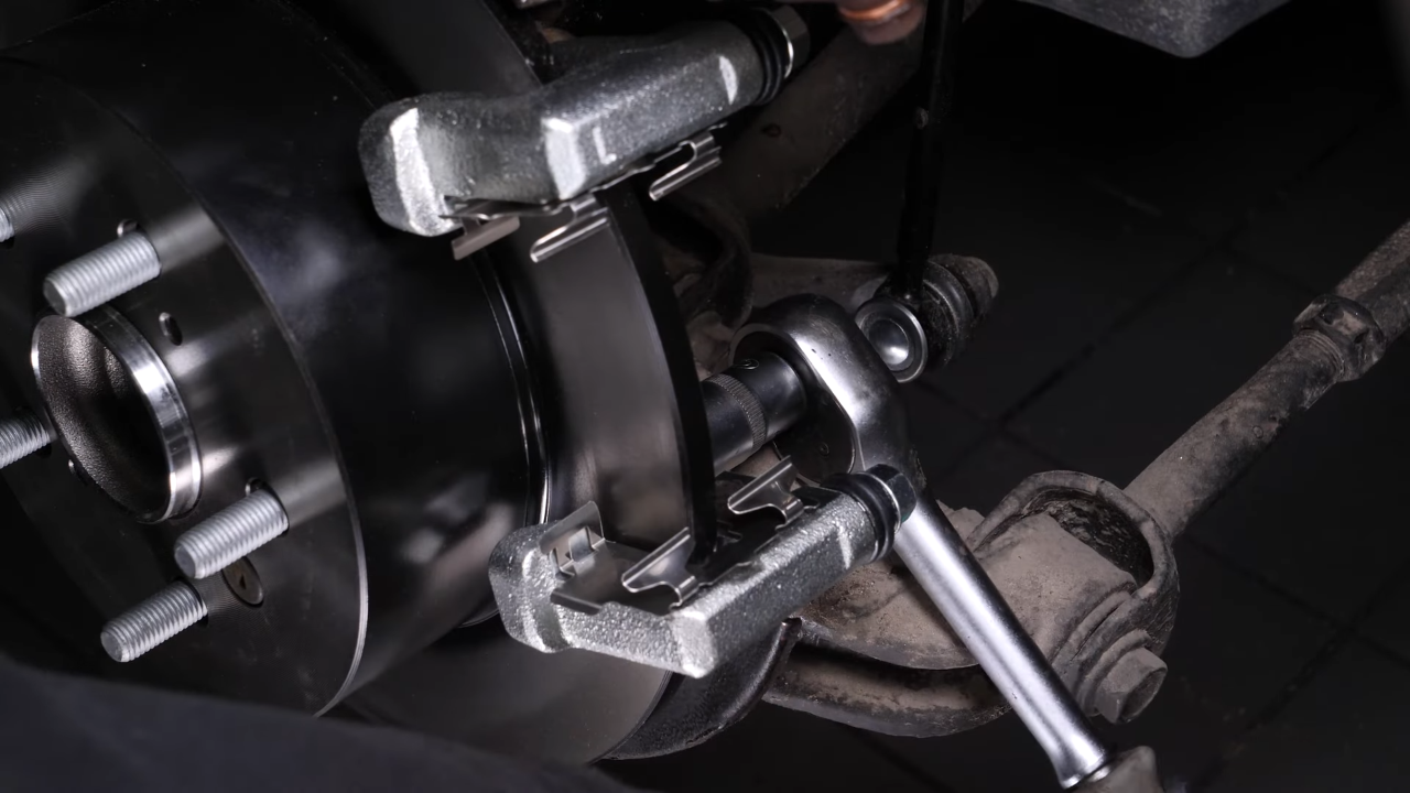 Put the brake caliper mount back on