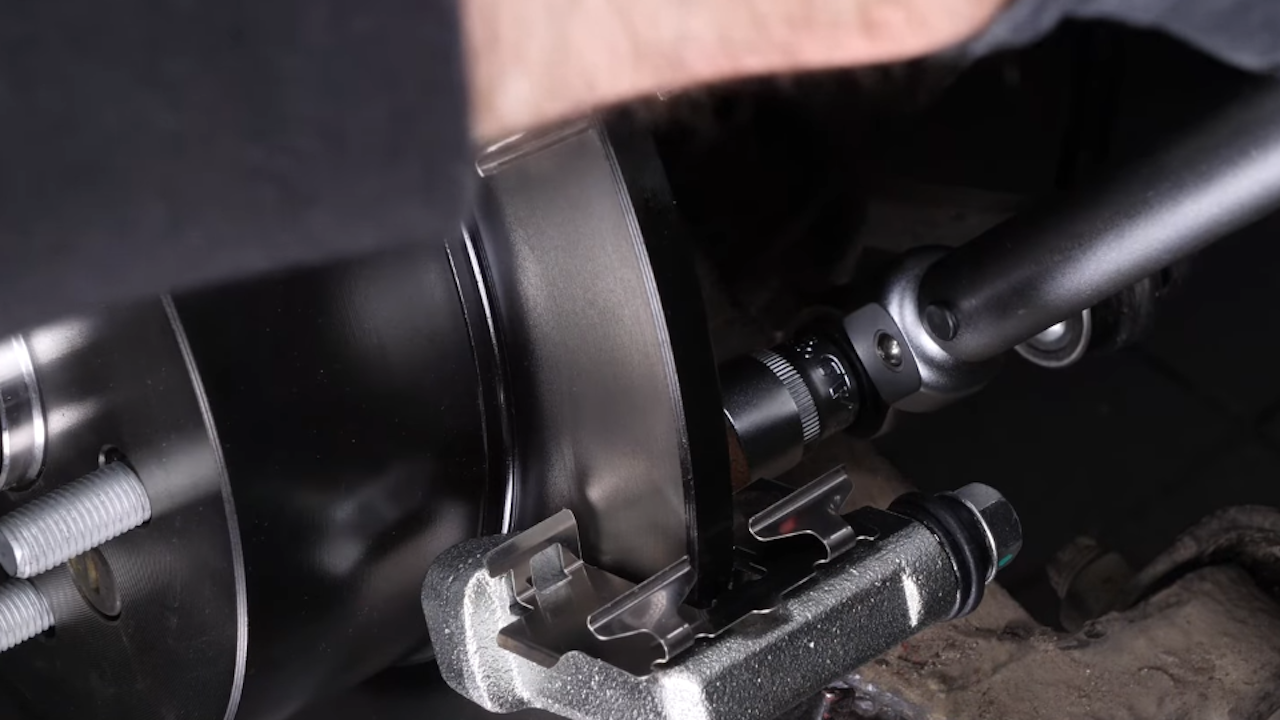 Put the brake caliper mount back on