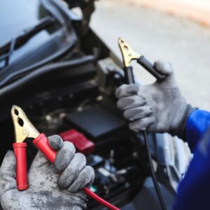 person holding jumper cables