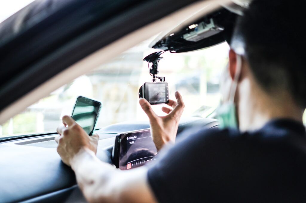 man setting up a dash camera for his car