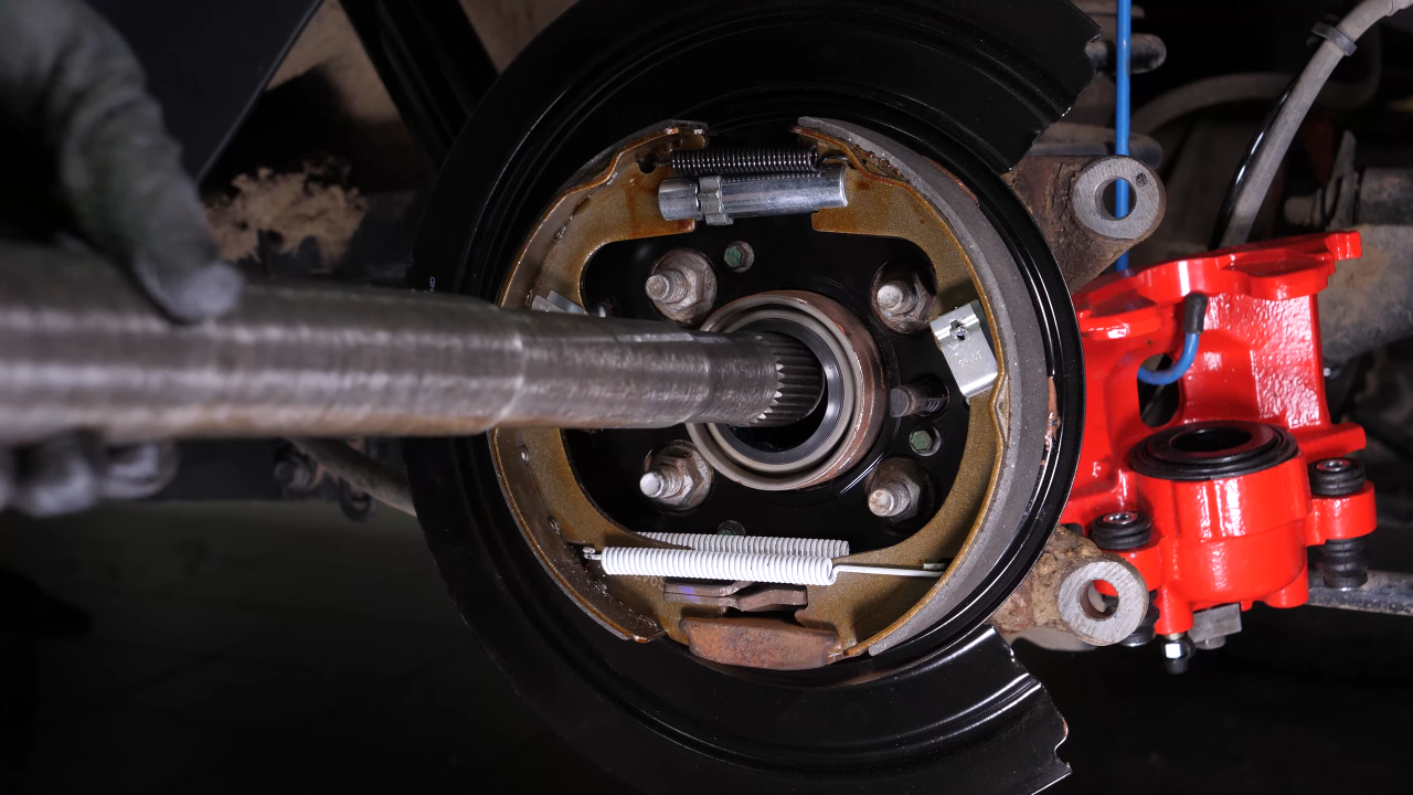 Put the rear axle shaft back in place