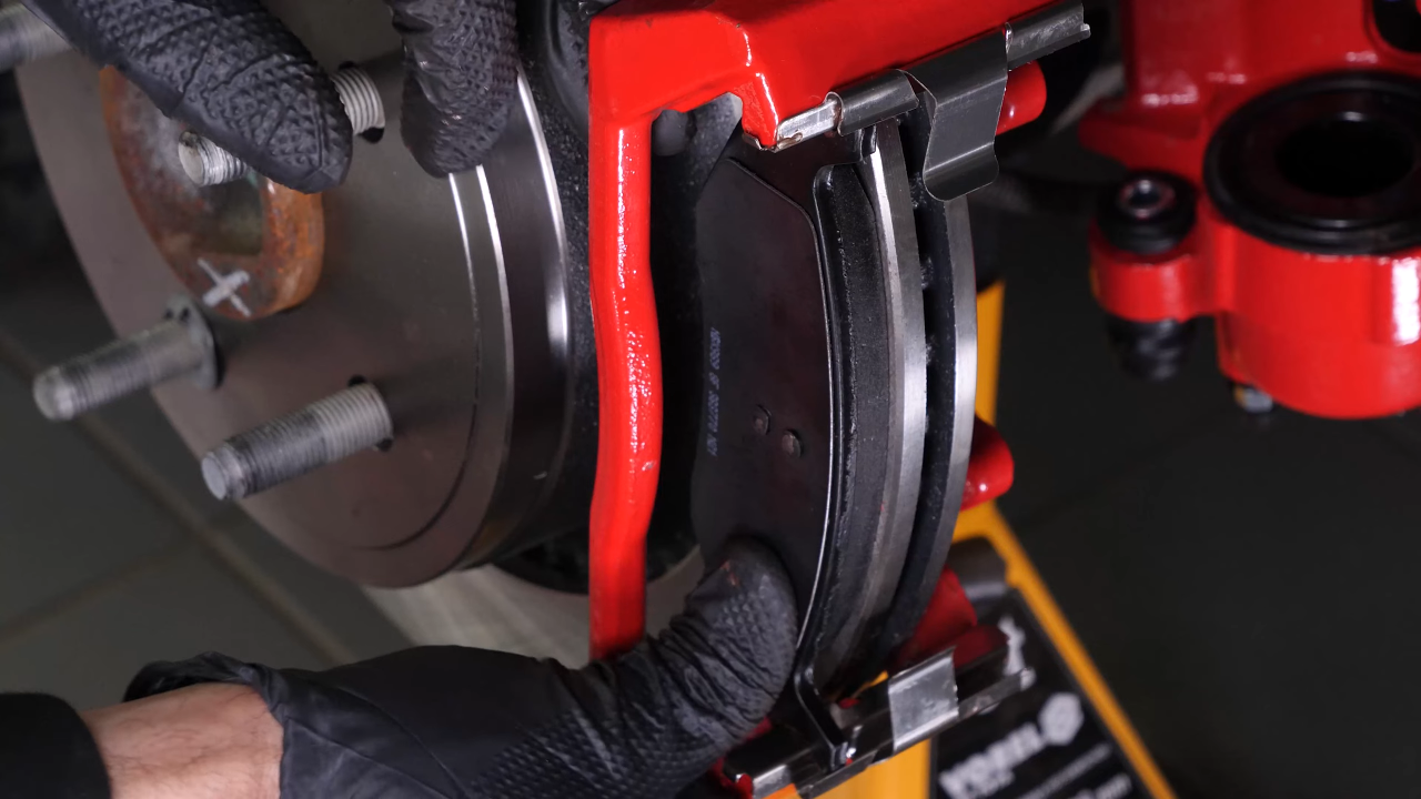 Put the rear brake system back