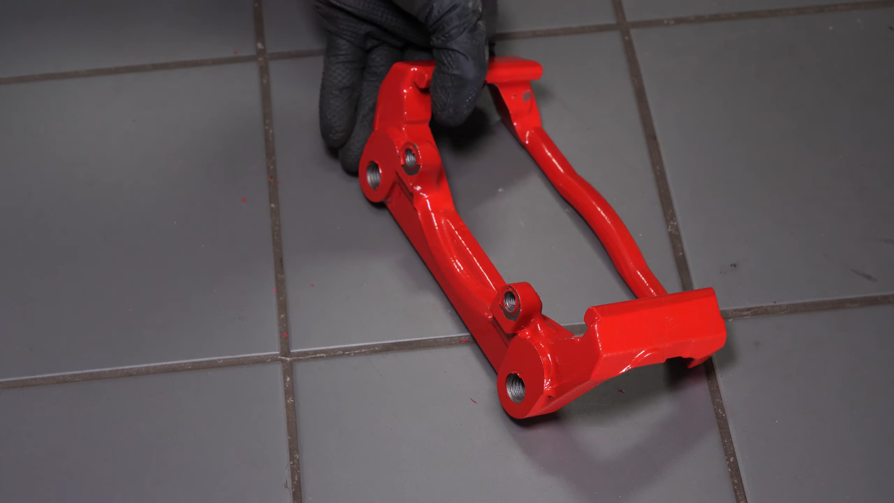 Put the brake caliper mount back on