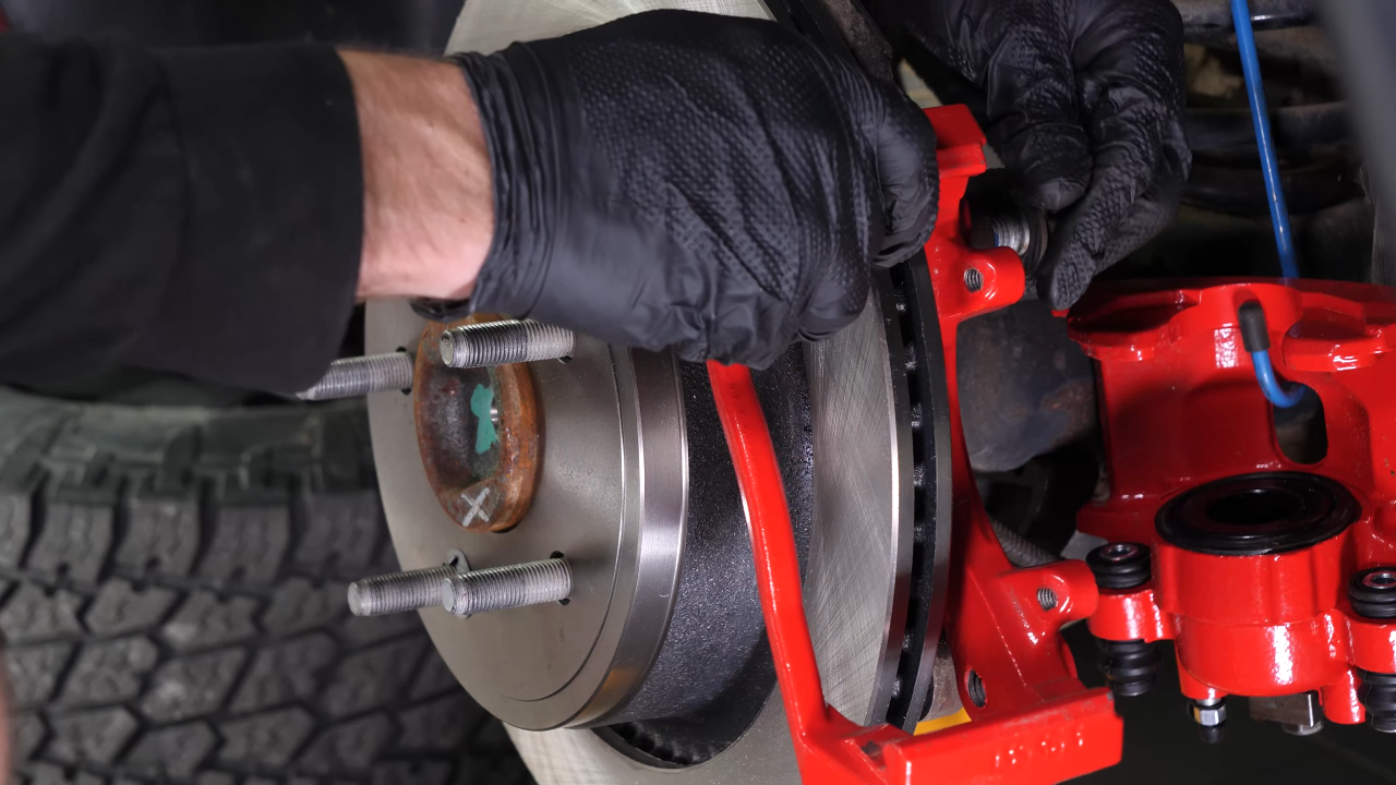 Put the brake caliper mount back on