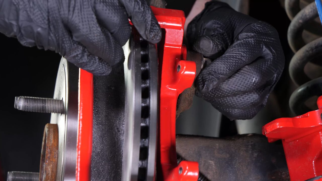 Put the brake caliper mount back on