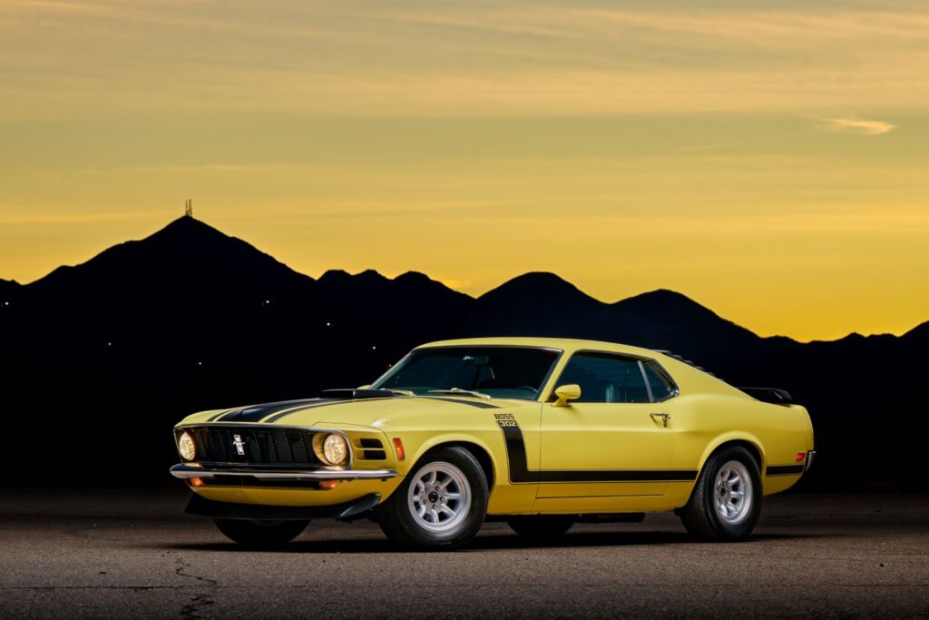 yellow ford mustang with sunset on the background