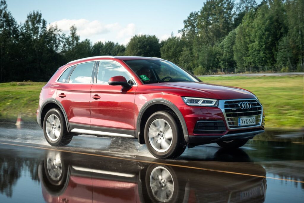 red 2019 audi q5 on a highway