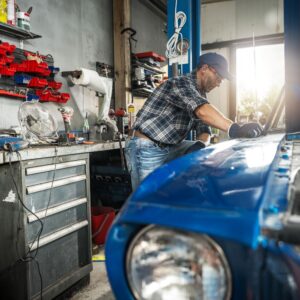 man doing DIY car restoration using home tools