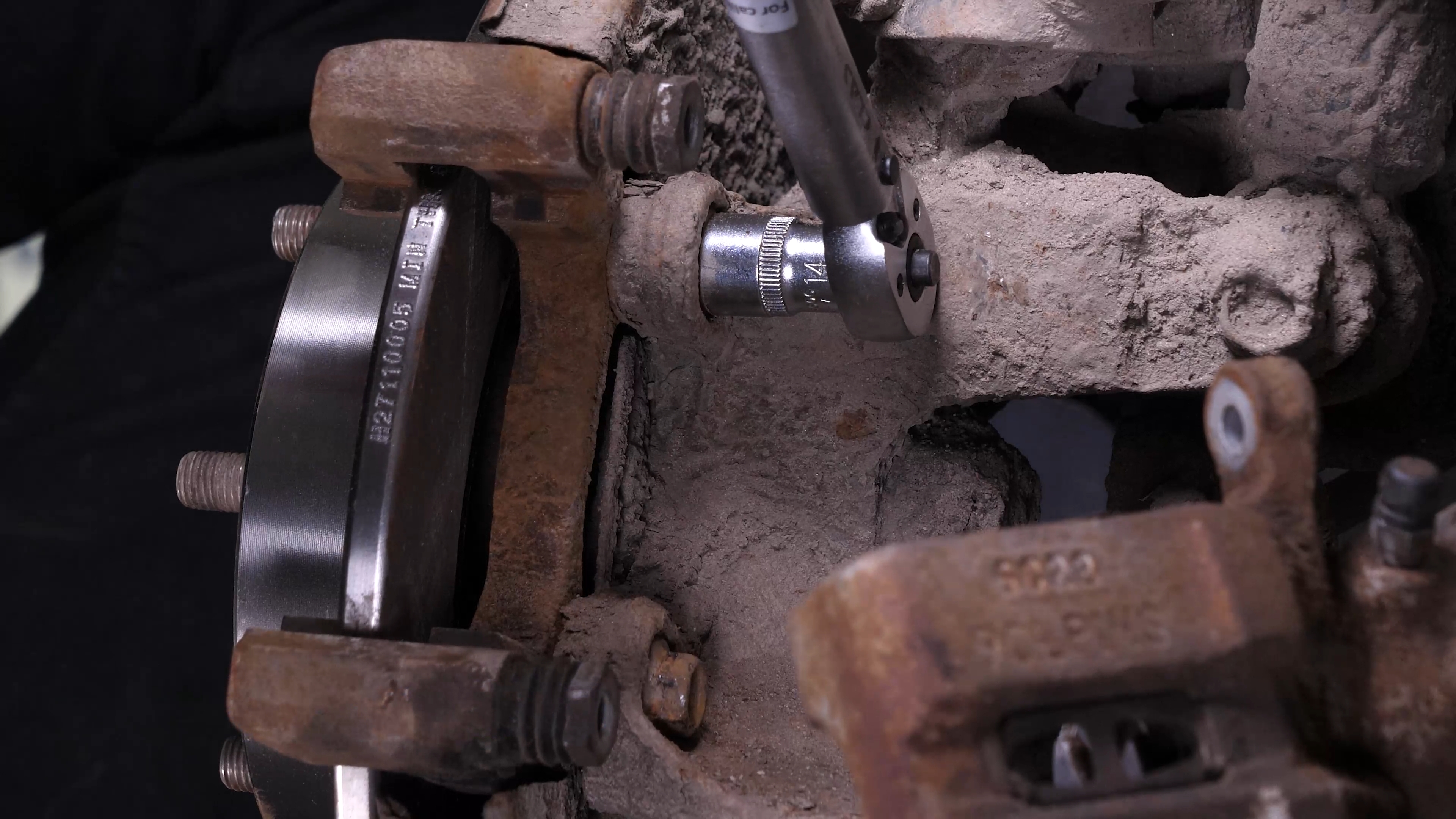 Put the brake caliper mount back on