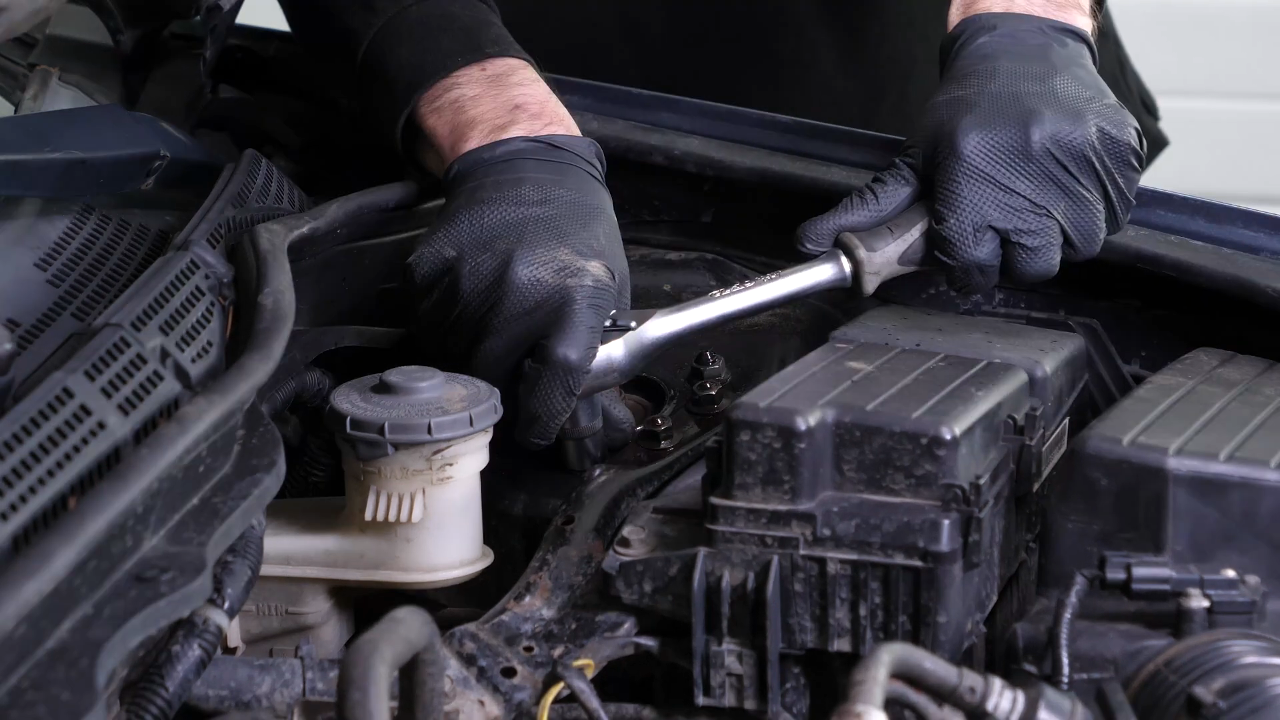 Unscrew the strut mount bearing nuts