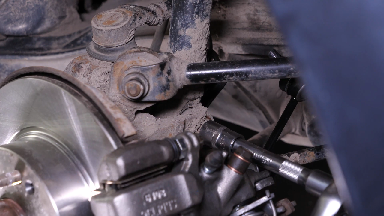 Unscrew the shock absorber foot