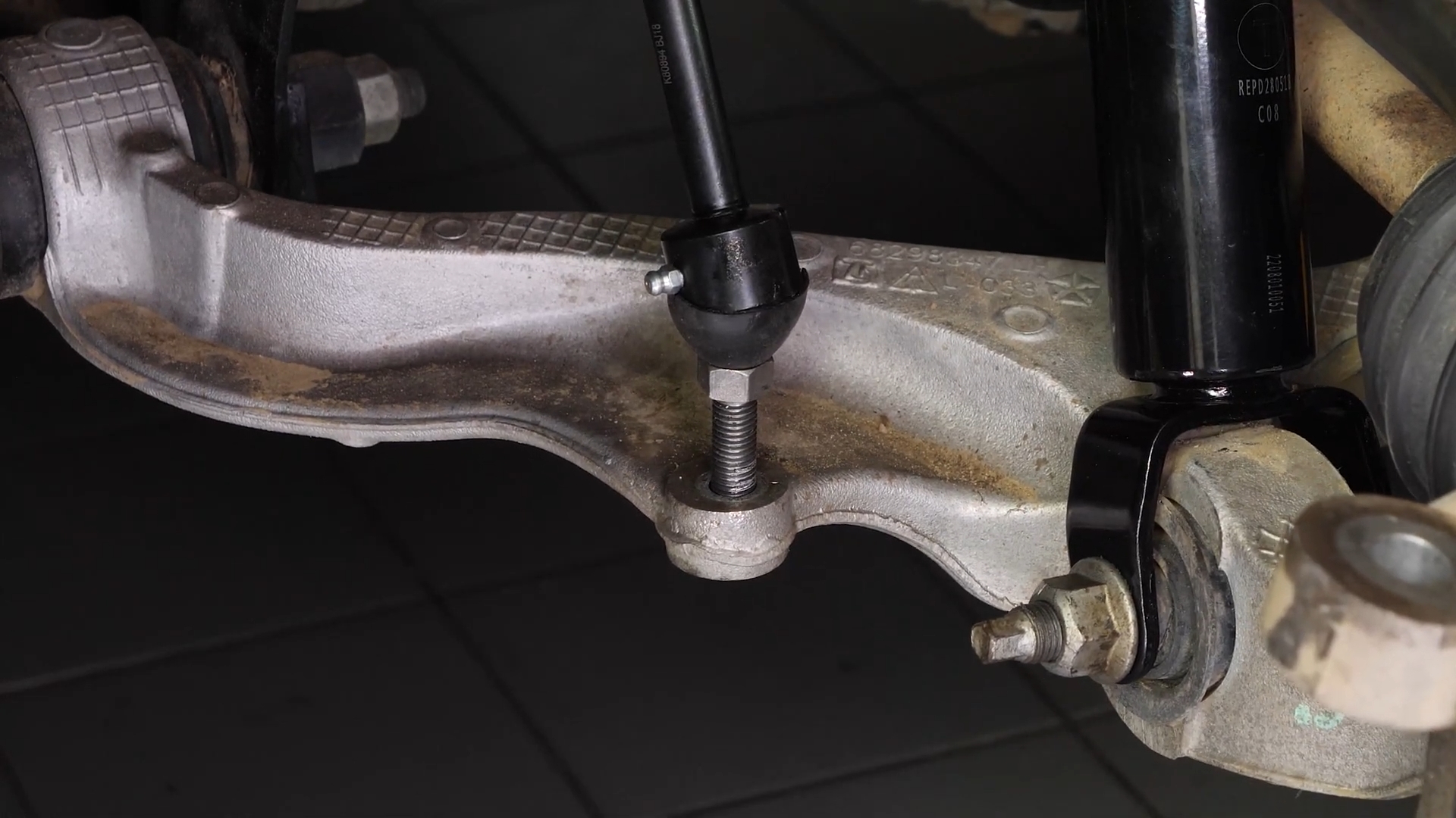 Screw the control arm ball joint nut back