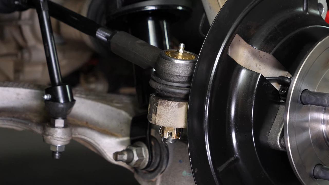 Disconnect the control arms from the wheel knuckle