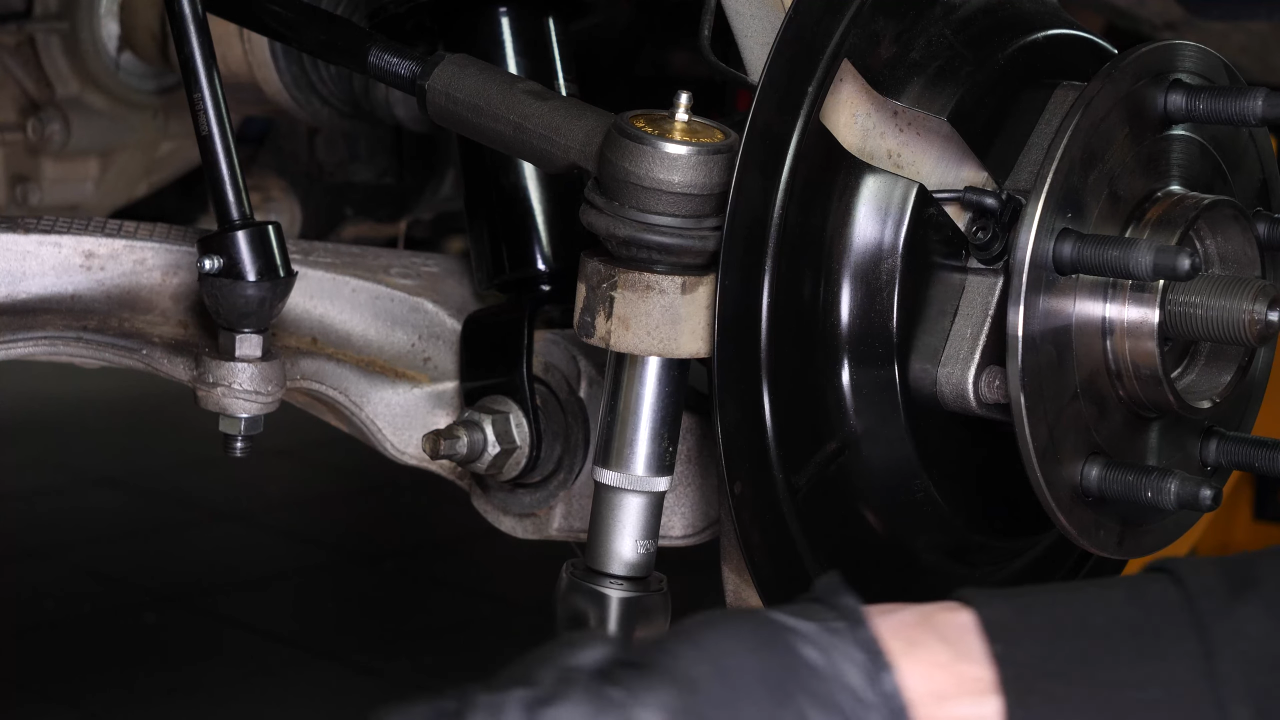 Disconnect the control arms from the wheel knuckle