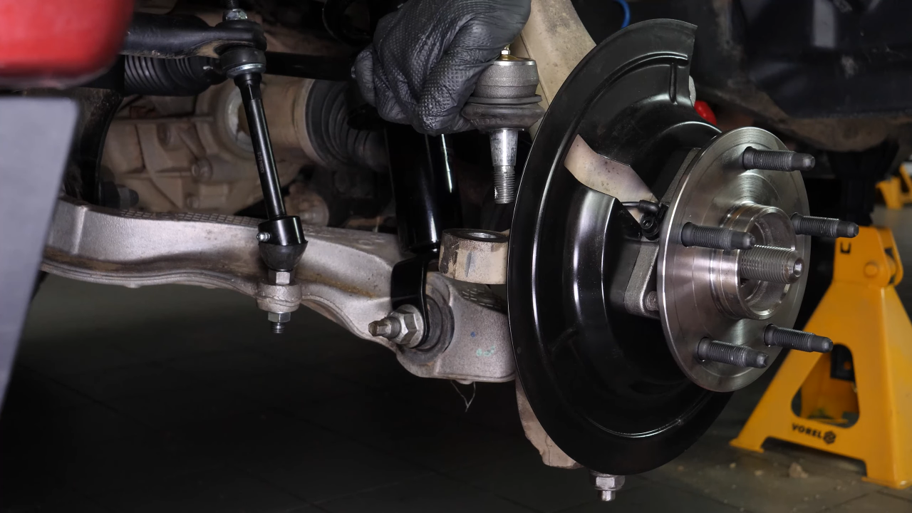 Disconnect the control arms from the wheel knuckle