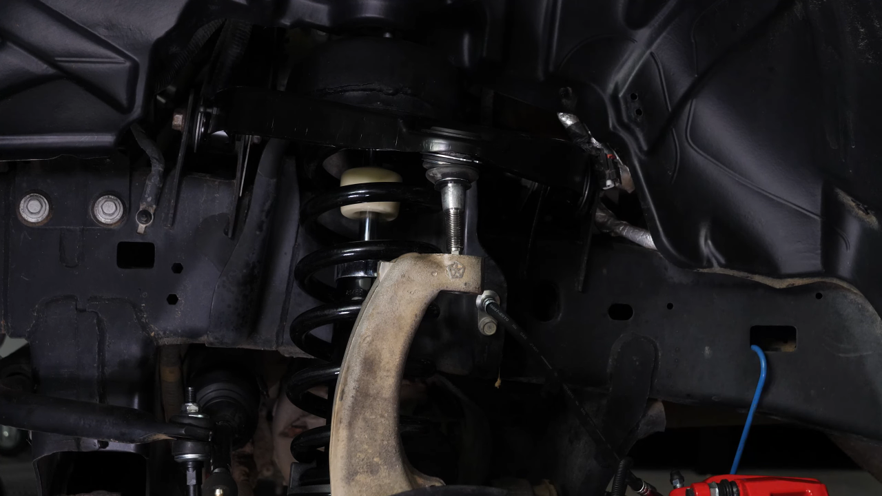 Disconnect the control arms from the wheel knuckle