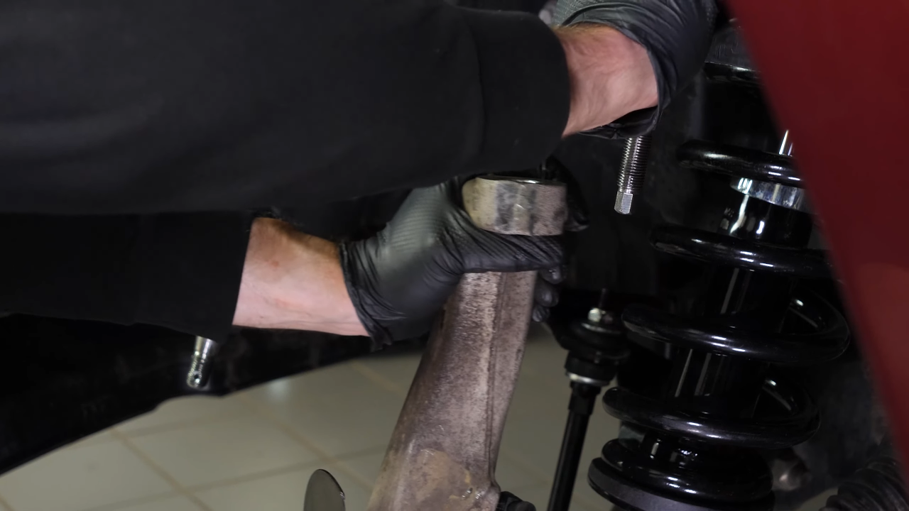 Disconnect the control arms from the wheel knuckle
