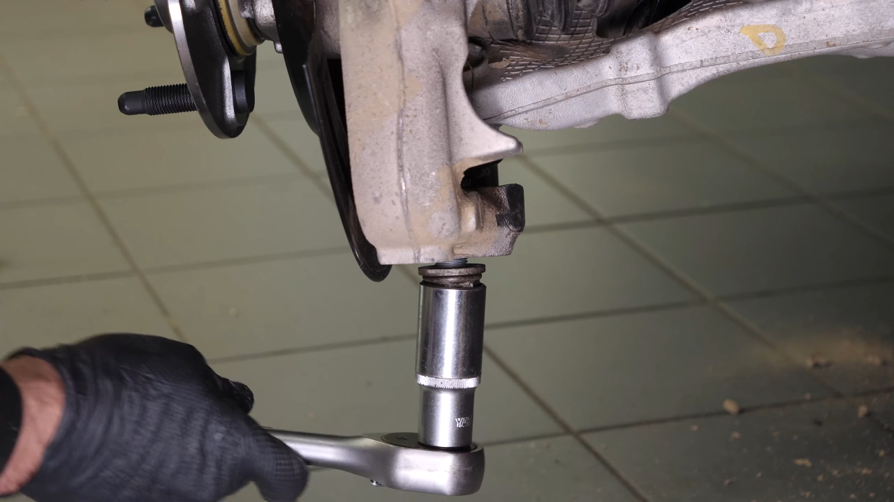 Disconnect the control arms from the wheel knuckle