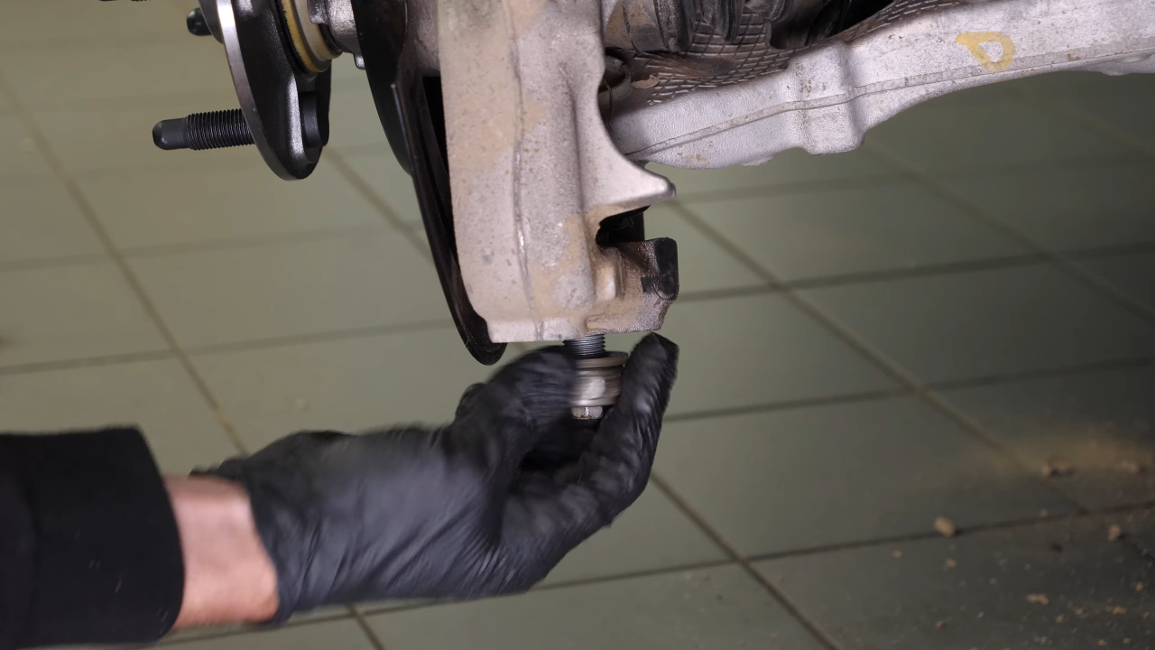 Disconnect the control arms from the wheel knuckle