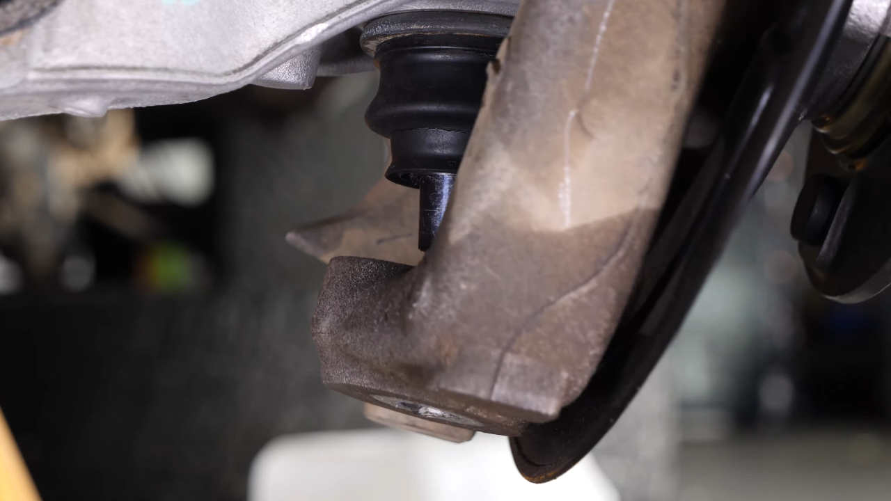 Screw the control arm ball joint nut back