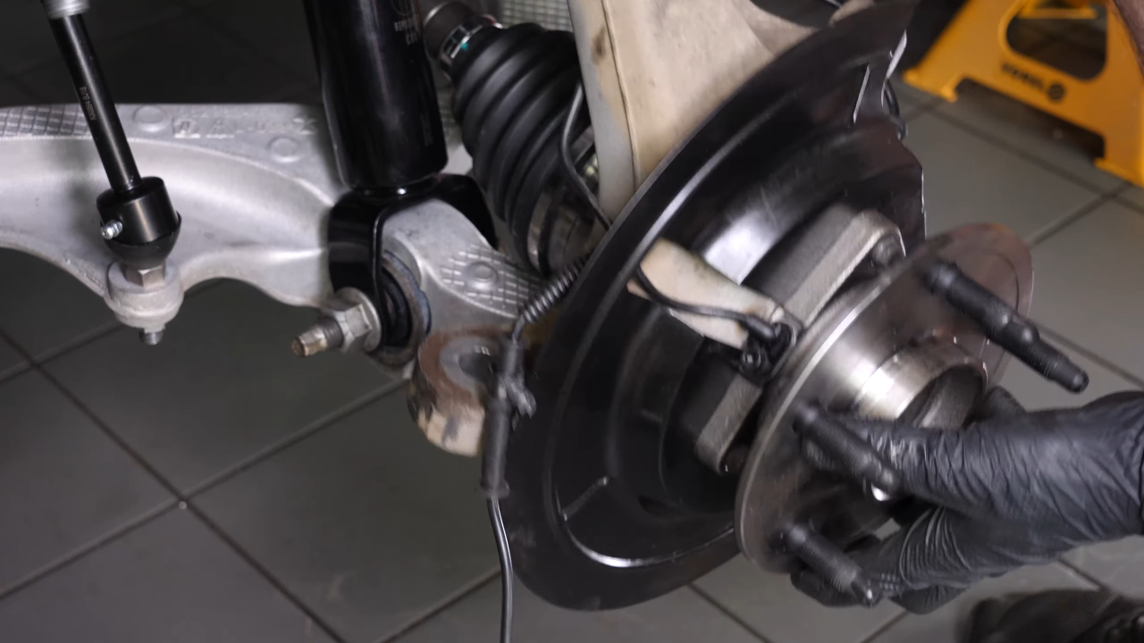 Screw the control arm ball joint nut back