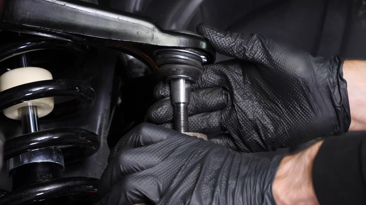 Screw the control arm ball joint nut back
