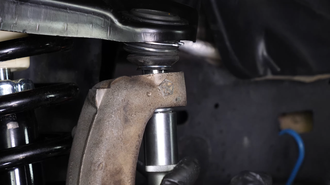 Screw the control arm ball joint nut back