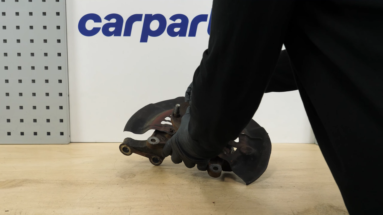 Remove the brake backing plate bolts