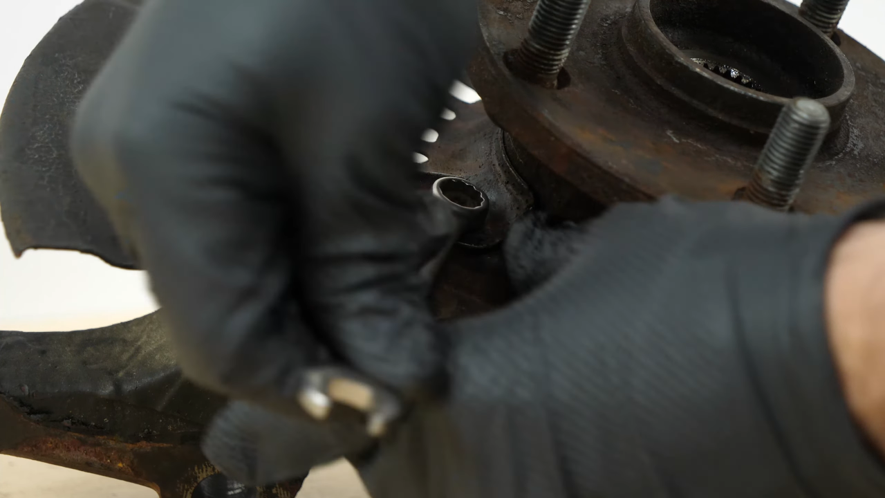 Remove the brake backing plate bolts