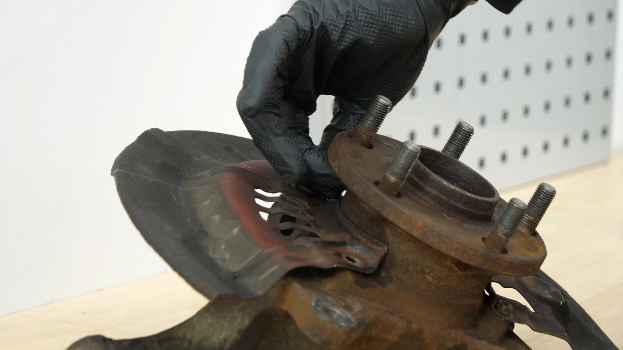 Remove the brake backing plate bolts