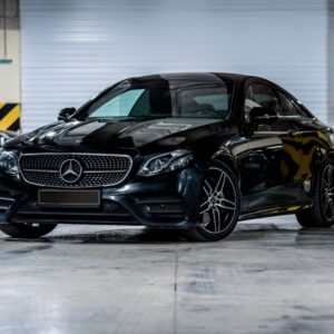 black Mercedes Benz E Class in a parking garage