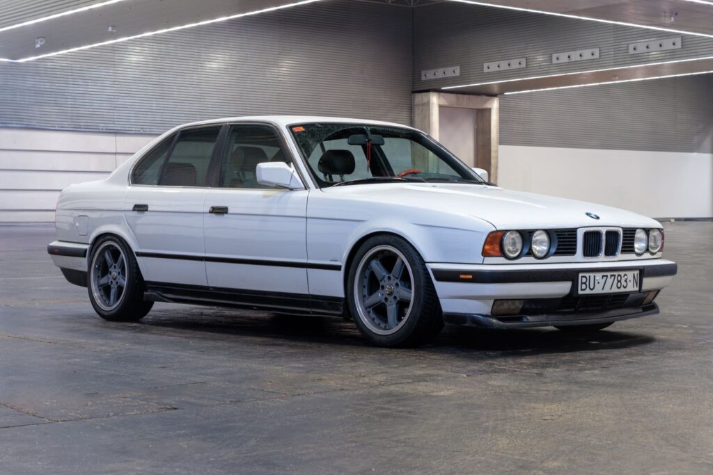side shot of a white bmw 5 e34