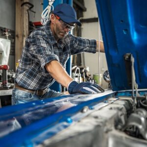 DIYer fixing a car inside a garage