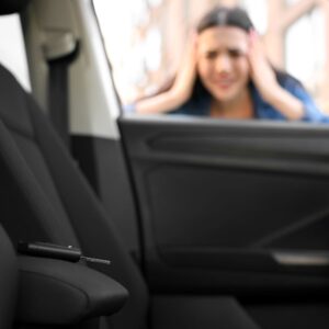 driver looking at the car keys left inside the vehicle