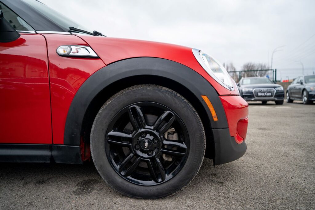 side shot of a mini cooper and passenger front wheel