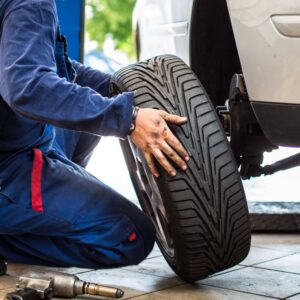 mechanic replacing a car's tire