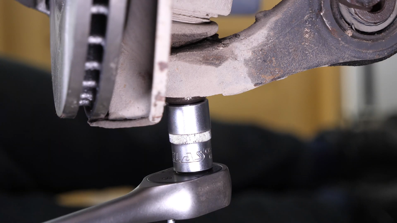 Disconnect the control arms from the wheel knuckle