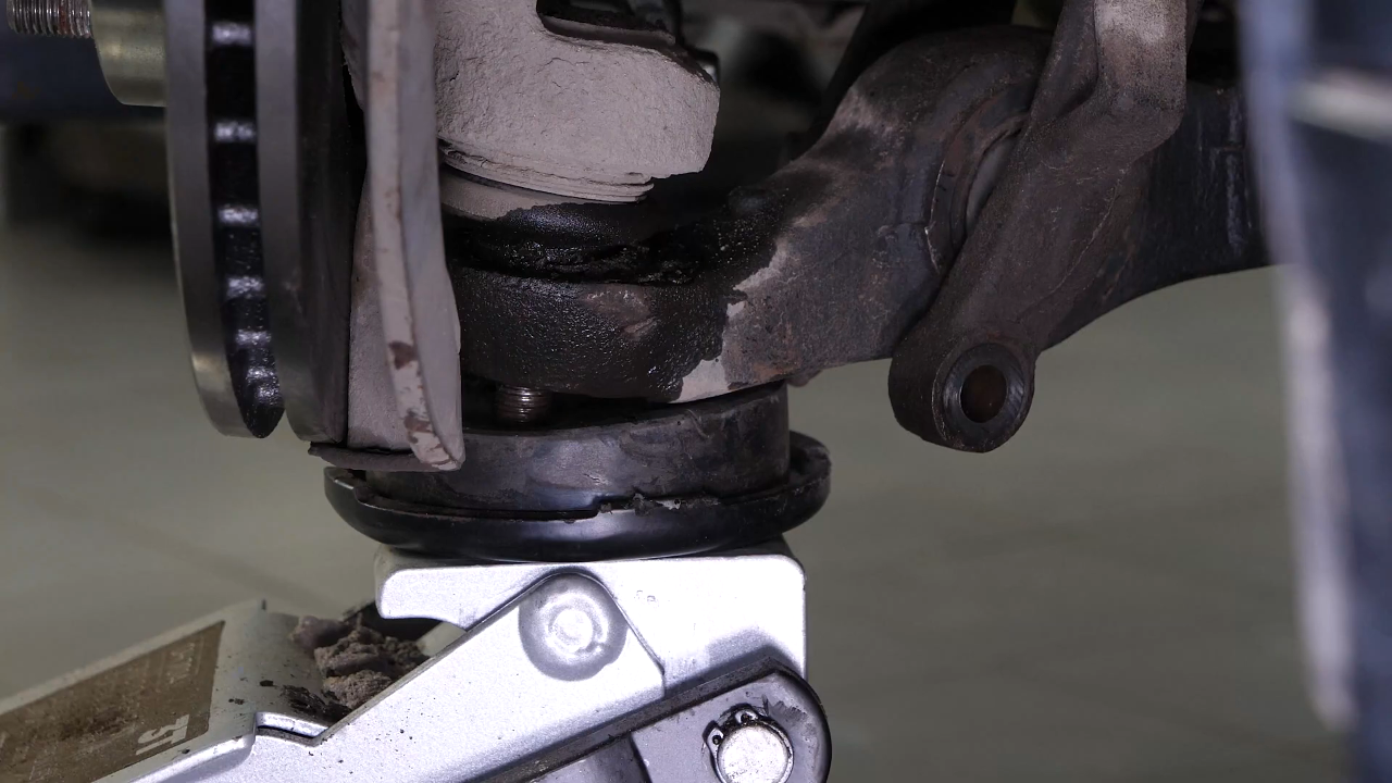 Disconnect the control arms from the wheel knuckle